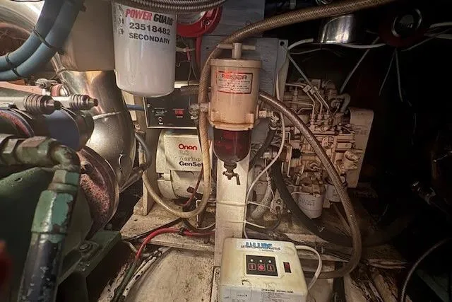 Slide: The Image of Engine room of a 1967 Hatteras 41 Twin Cabin with generator and fuel system components. - 45