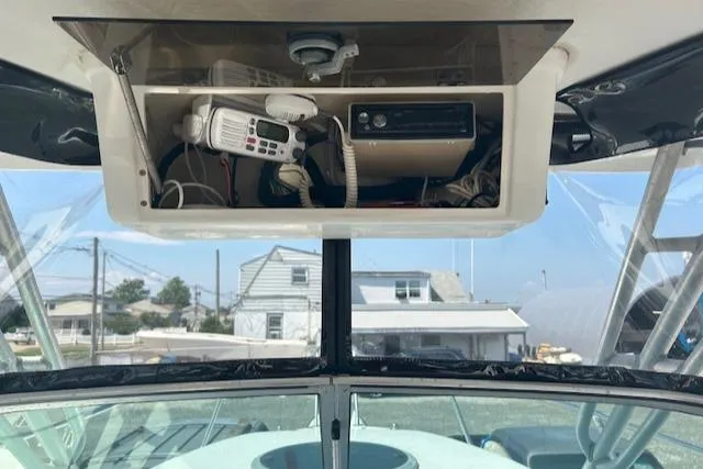 Slide: The Image of 2001 Seaswirl Striper 2601 Walkaround O/B boat dashboard with radio and equipment storage. - 11