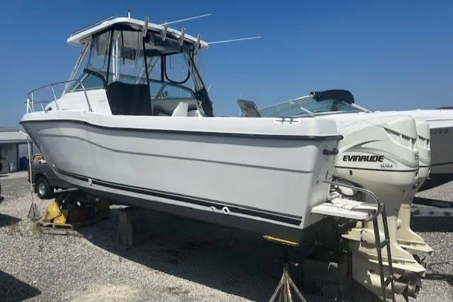 Slide: The Image of 2001 Seaswirl Striper 2601 Walkaround O/B boat with Evinrude engine on dry dock. - 2