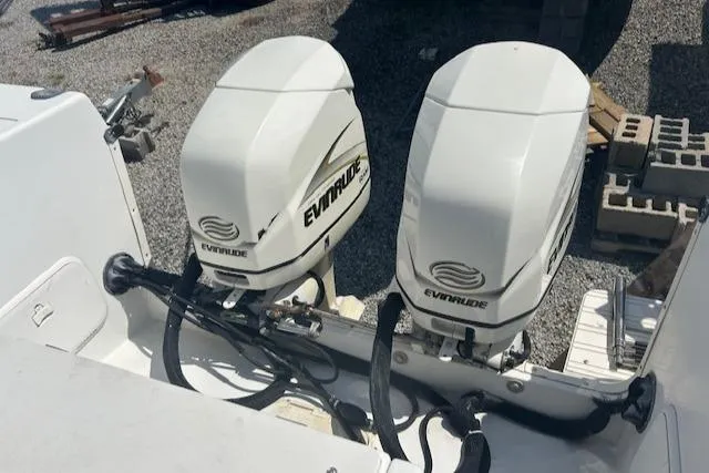 Slide: The Image of Twin Evinrude outboard motors on a 2001 Seaswirl Striper 2601 Walkaround boat. - 5