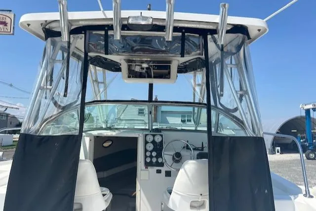 Slide: The Image of 2001 Seaswirl Striper 2601 Walkaround O/B boat cockpit with steering wheel and controls. - 6
