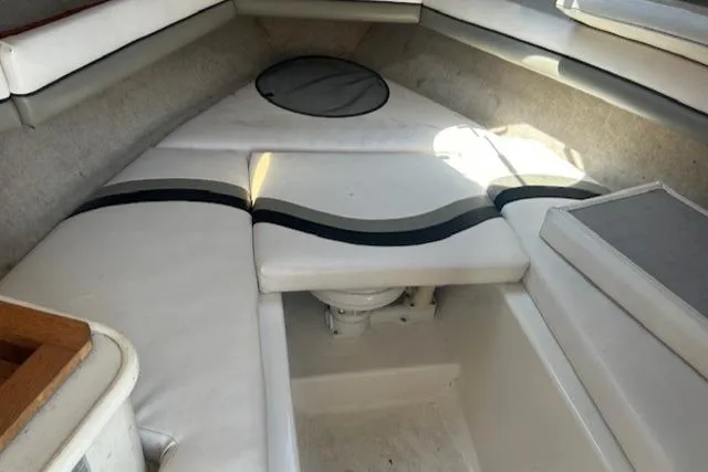 Slide: The Image of 2001 Seaswirl Striper 2601 Walkaround O/B cabin interior with white cushioned seating. - 8