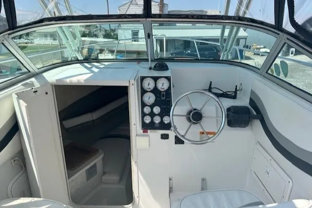 Slide: The Image of 2001 Seaswirl Striper 2601 Walkaround O/B boat interior with steering wheel and cabin entrance. - 9