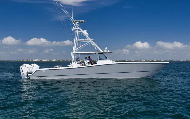 The Image of 2022 Freeman 47 boat cruising on open water under a clear blue sky. - 1