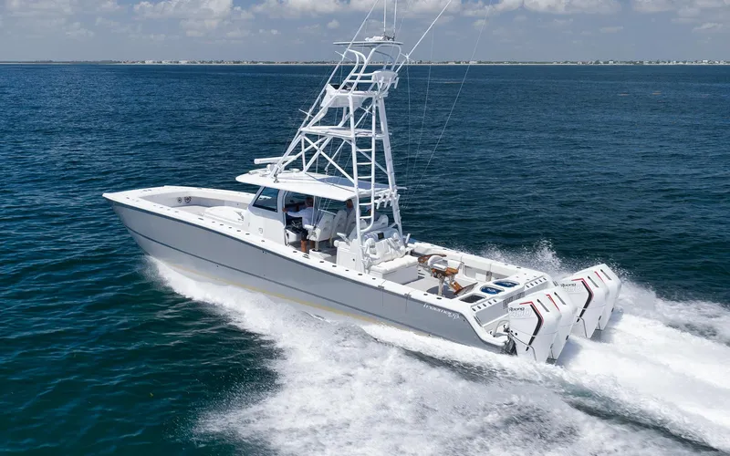 Slide: The Image of 2022 Freeman 47 boat cruising on open water with multiple outboard engines. - 16