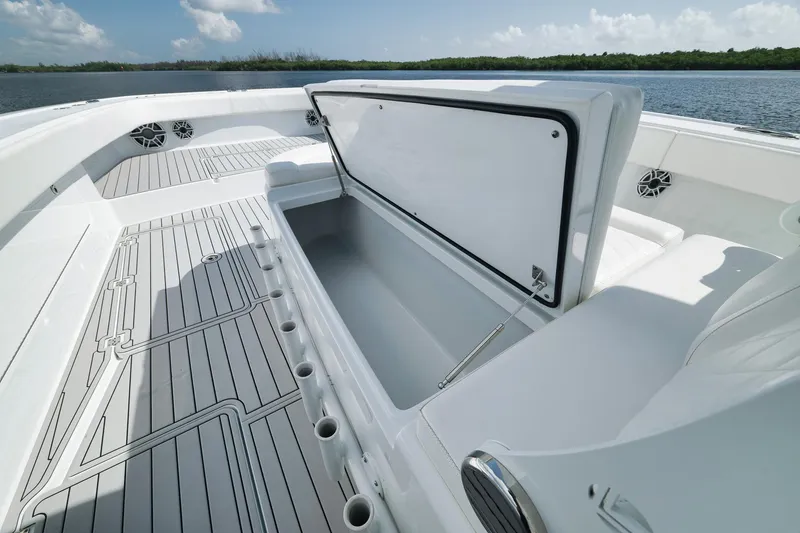 Slide: The Image of 2022 Freeman 47 boat interior with open storage compartment, sleek design, and scenic water view. - 22