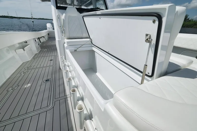 Slide: The Image of 2022 Freeman 47 boat interior with open storage compartment and rod holders. - 25