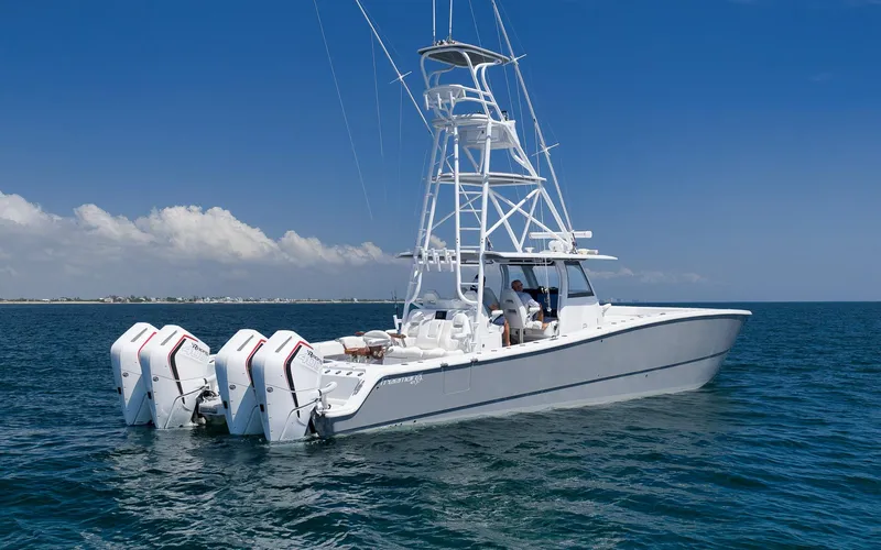 Slide: The Image of 2022 Freeman 47 boat with four engines on open water under clear blue sky. - 3