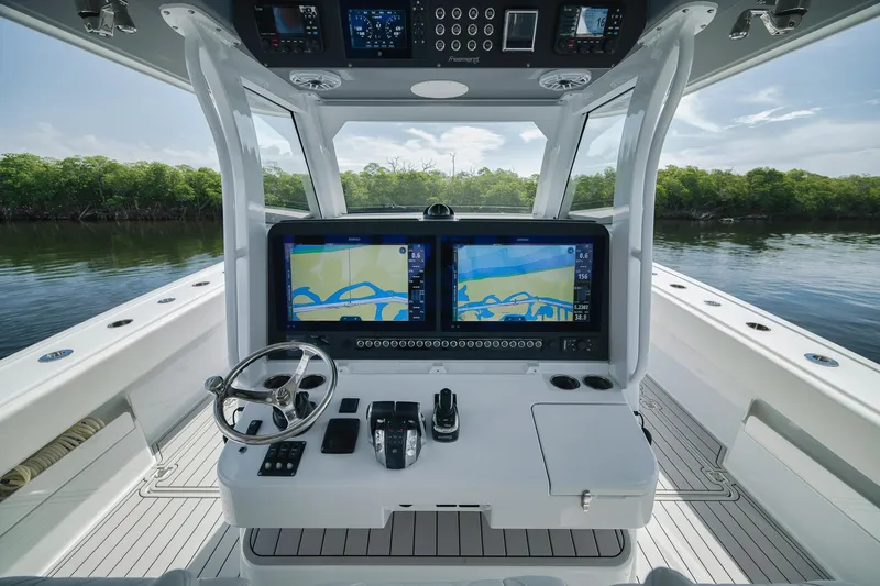 Slide: The Image of Helm of 2022 Freeman 47 boat with dual navigation screens and steering wheel. - 33