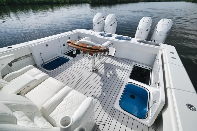 Slide: The Image of Luxurious 2022 Freeman 47 boat interior with white seating and multiple outboard engines. - 37