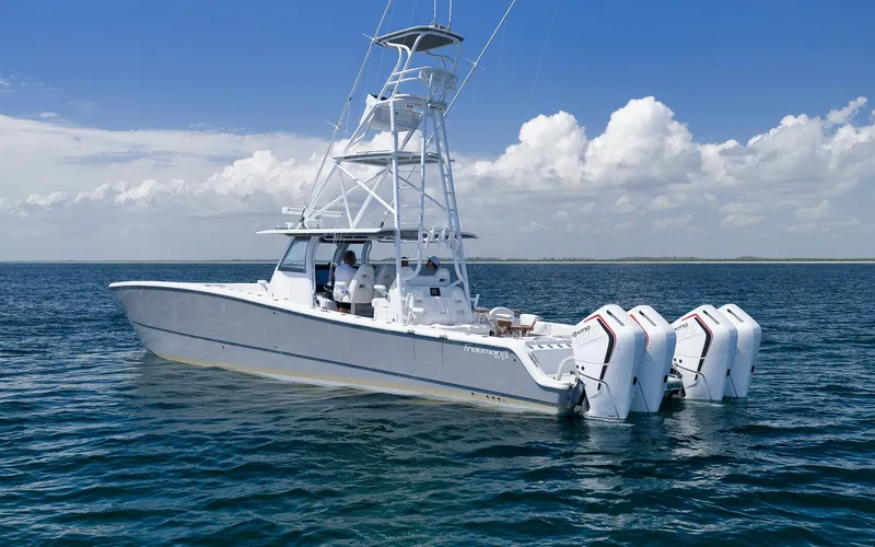 Slide: The Image of 2022 Freeman 47 boat on open water with clear skies and four engines. - 4