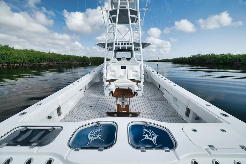 Slide: The Image of Luxury Freeman 47 boat interior, 2022 model, featuring spacious deck and fishing amenities on calm waters. - 42