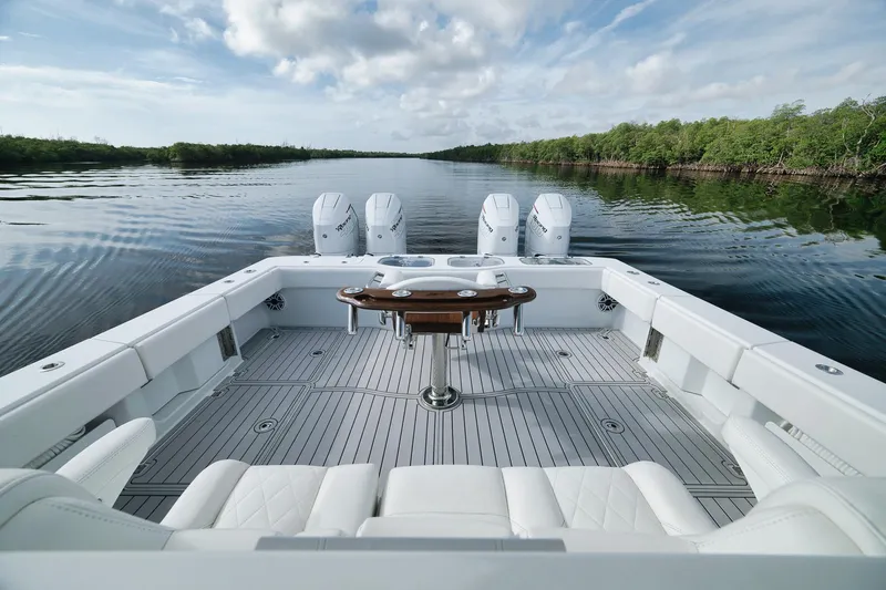 Slide: The Image of Freeman 47 boat, 2022 model, with spacious deck and multiple engines on a calm waterway. - 43