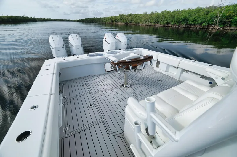 Slide: The Image of 2022 Freeman 47 boat with spacious deck and four engines on a calm river. - 44