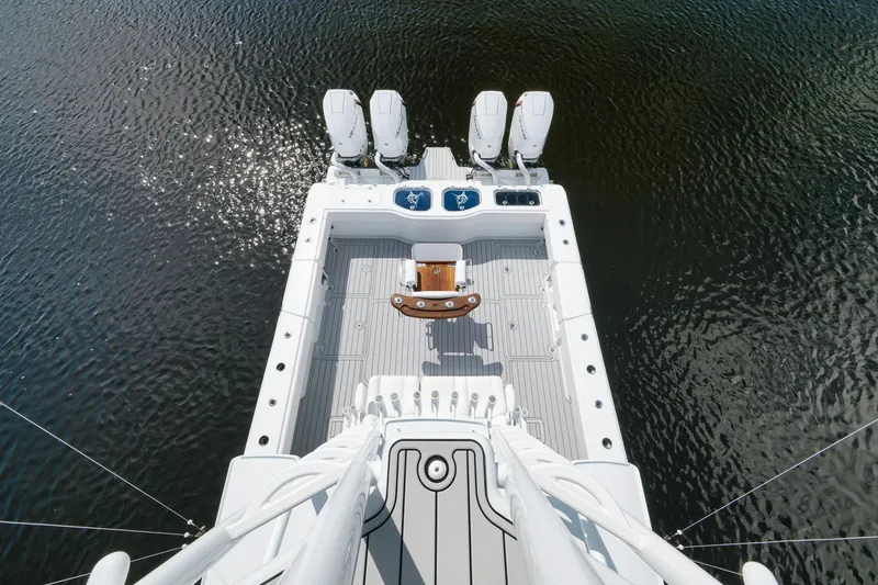 Slide: The Image of Aerial view of 2022 Freeman 47 boat deck with four engines on water. - 47