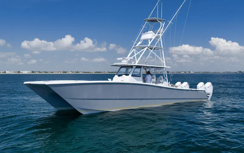 Slide: The Image of 2022 Freeman 47 boat on calm blue water under clear sky. - 6