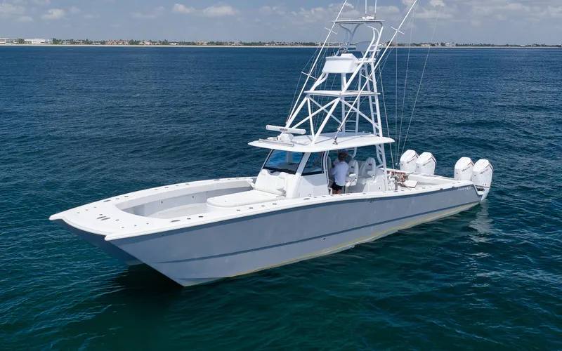 Slide: The Image of 2022 Freeman 47 boat on open water, featuring multiple outboard engines and a sleek design. - 7