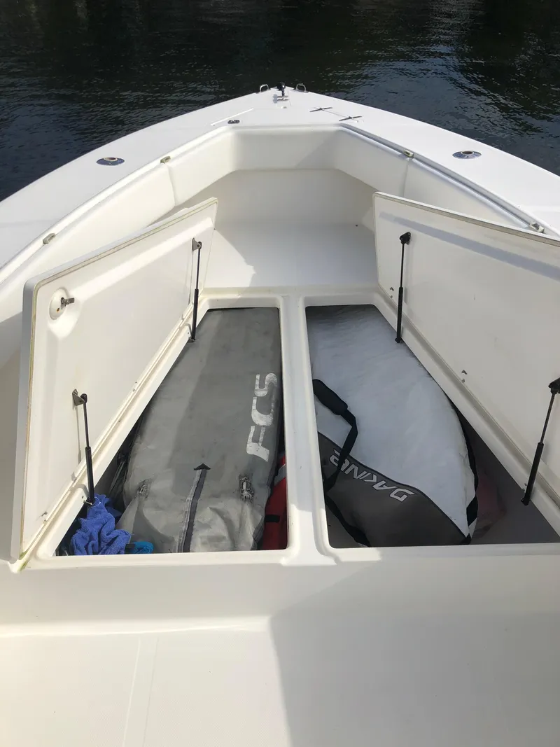 Slide: The Image of Open storage compartments on a 2000 Venture 34 Open boat, containing surfboard bags. - 14