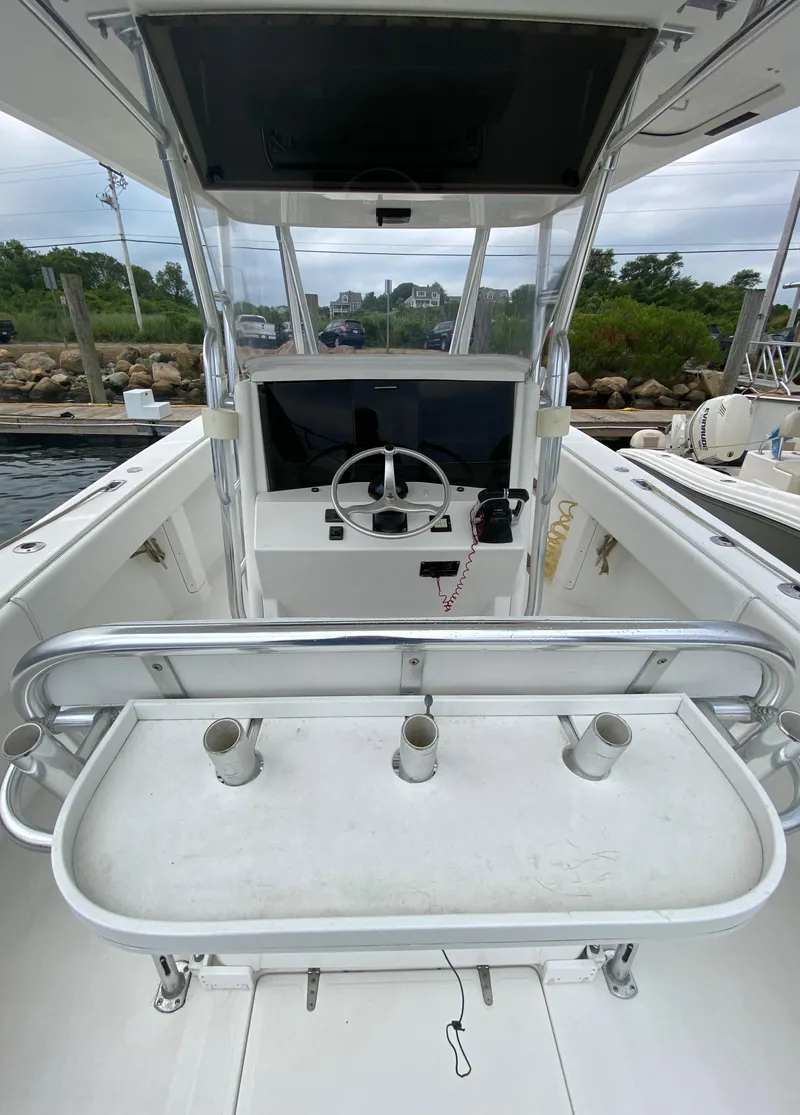 Slide: The Image of 2000 Venture 34 Open boat cockpit with steering wheel and rod holders. - 15