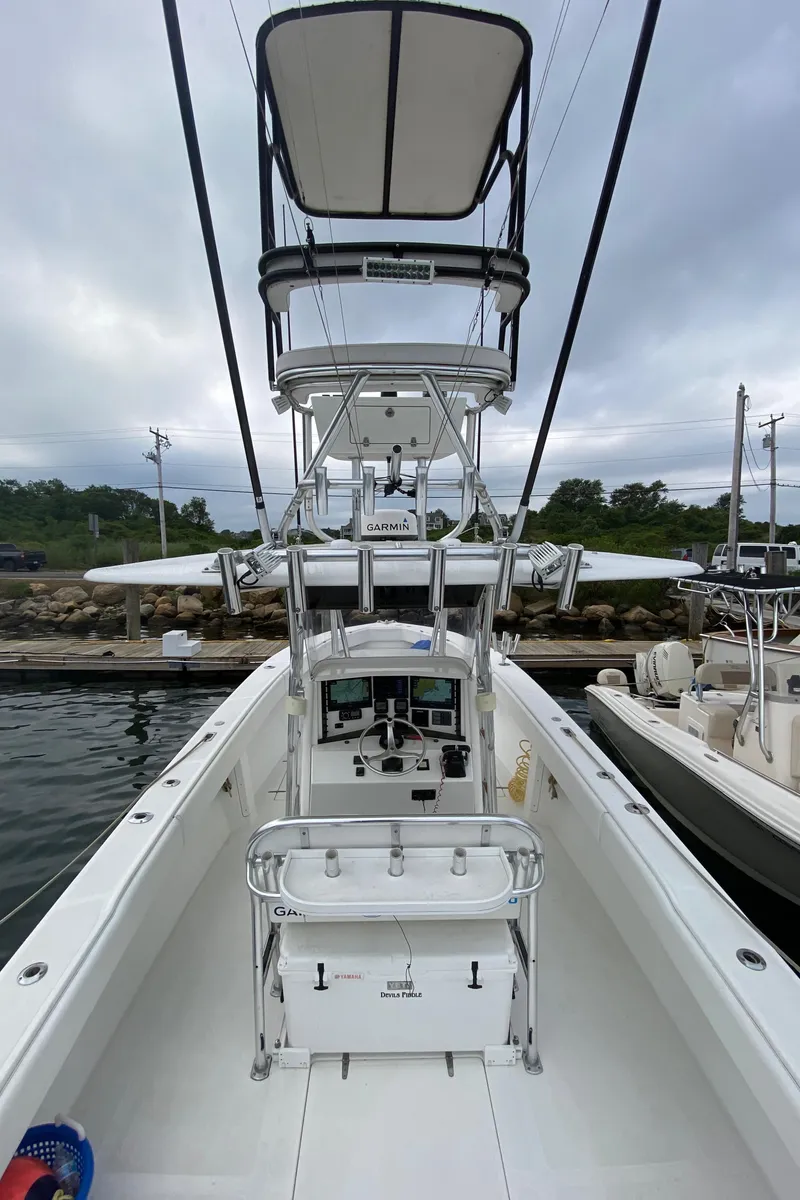Slide: The Image of 2000 Venture 34 Open boat with dual consoles and tower, docked at marina. - 18