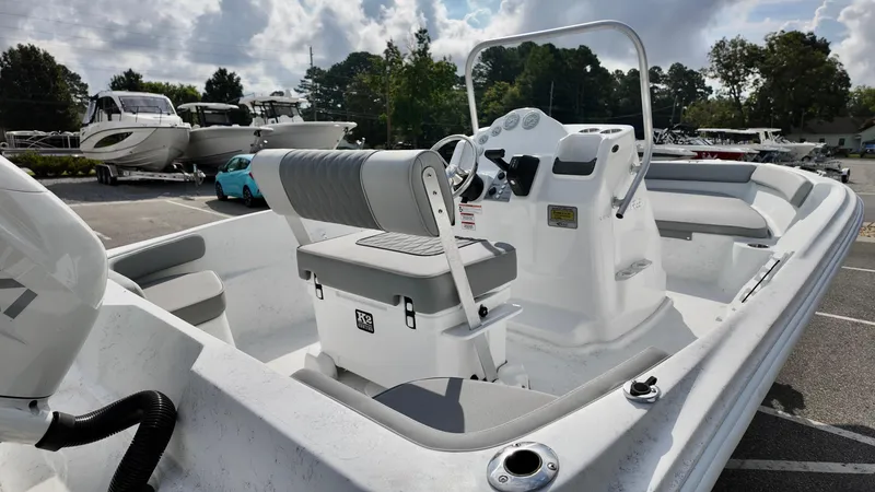 Slide: The Image of 2026 ALK2 Powerboats 18 CRS, sleek white design, parked in a marina. - 3