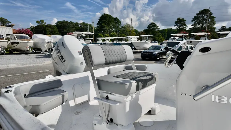 Slide: The Image of 2026 ALK2 Powerboats 18 CRS with Suzuki engine, parked among other boats under a cloudy sky. - 4