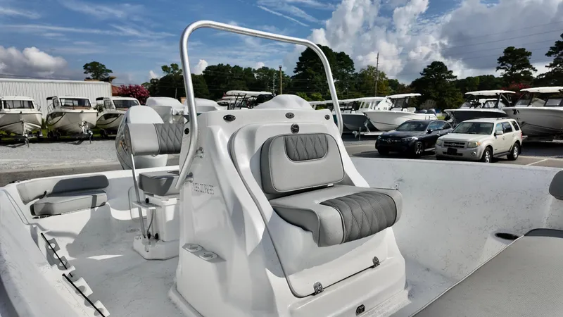 Slide: The Image of 2026 ALK2 Powerboats 18 CRS with sleek seating, parked among other boats and cars. - 5