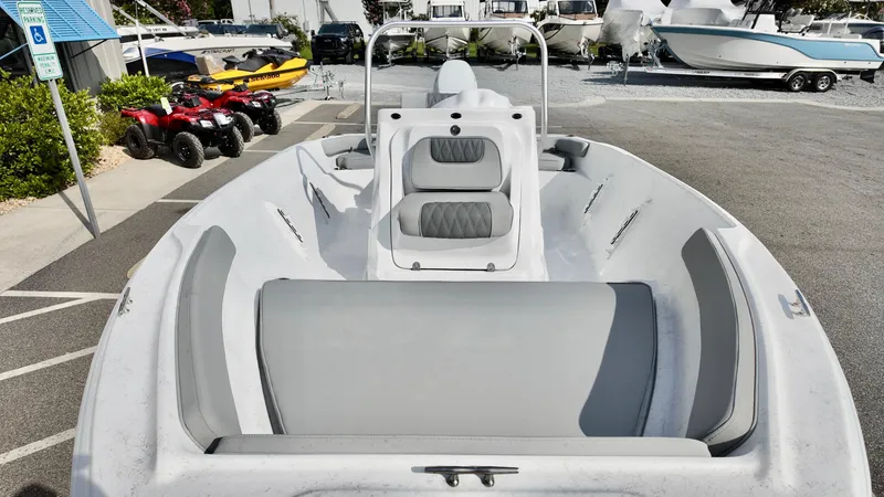 Slide: The Image of 2026 ALK2 Powerboats 18 CRS with gray seating, parked near other boats and ATVs. - 6