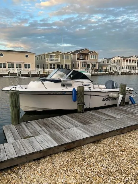 Slide: The Image of Grady-White Adventure 208 boat docked by waterfront homes, 2000 model. - 4