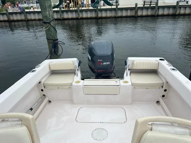 Slide: The Image of 2000 Grady-White Adventure 208 boat with Yamaha engine, docked in a marina. - 6