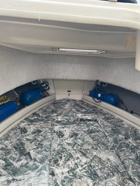 Slide: The Image of Interior cabin of 2000 Grady-White Adventure 208 boat with storage and cushions. - 8