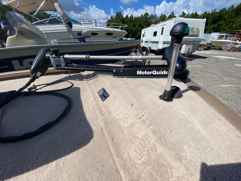 Slide: The Image of Boat deck with MotorGuide trolling motor, Fisher 1600, 2006 model, in a marina setting. - 4