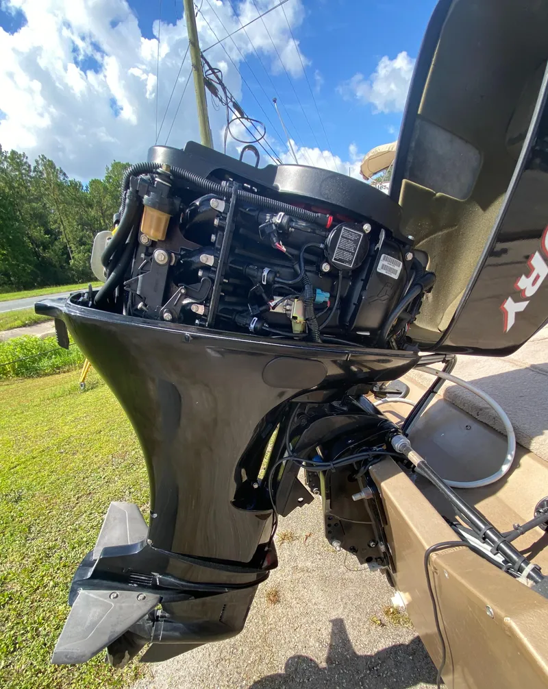 Slide: The Image of 2006 Fisher 1600 outboard motor with open cover, showing engine components. - 7