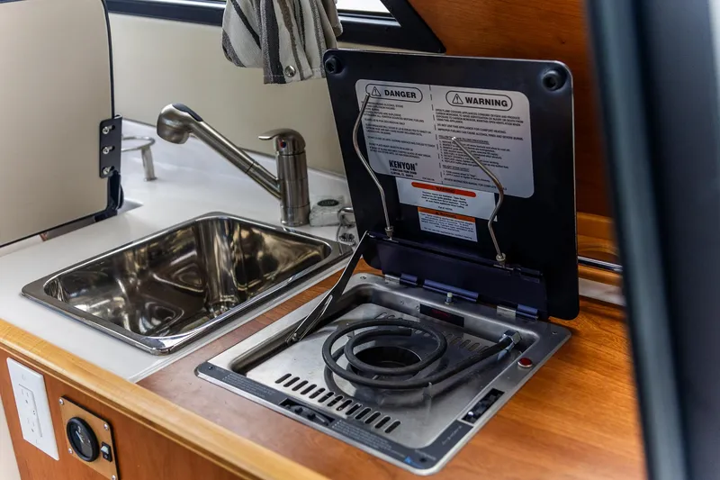 Slide: The Image of 2023 Cutwater C-248 Coupe kitchen area with sink and stove. - 15