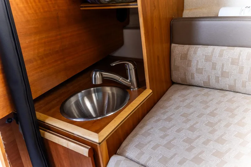 Slide: The Image of 2023 Cutwater C-248 Coupe interior with sink and patterned seating. - 17