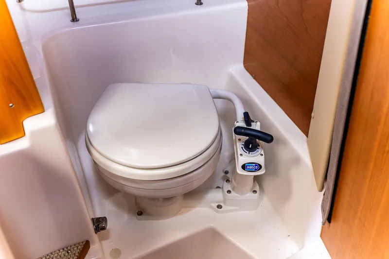 Slide: The Image of 2023 Cutwater C-248 Coupe marine toilet with Jabsco pump in compact bathroom. - 20