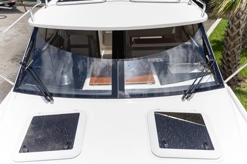 Slide: The Image of 2023 Cutwater C-248 Coupe boat with sleek windshield and dual hatches. - 23
