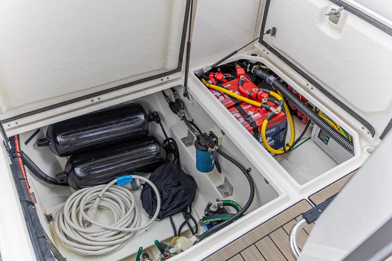Slide: The Image of 2023 Cutwater C-248 Coupe engine compartment with batteries, cables, and equipment. - 6