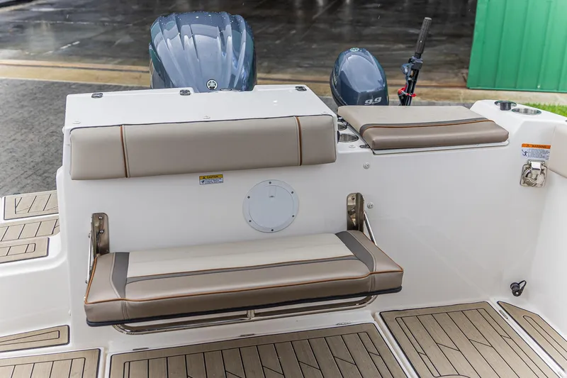 Slide: The Image of 2023 Cutwater C-248 Coupe boat interior with cushioned seating and outboard motor. - 7