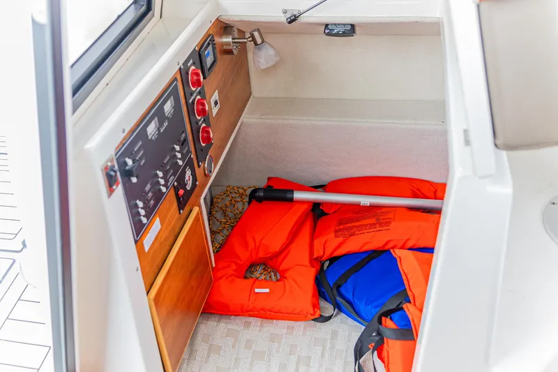 Slide: The Image of 2023 Cutwater C-248 Coupe interior with life jackets and control panel. - 8