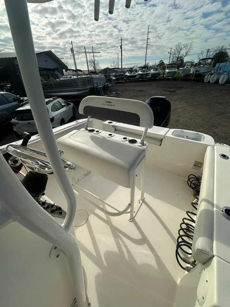 Slide: The Image of 2022 Cobia 220 Center Console boat interior with seating and storage. - 16