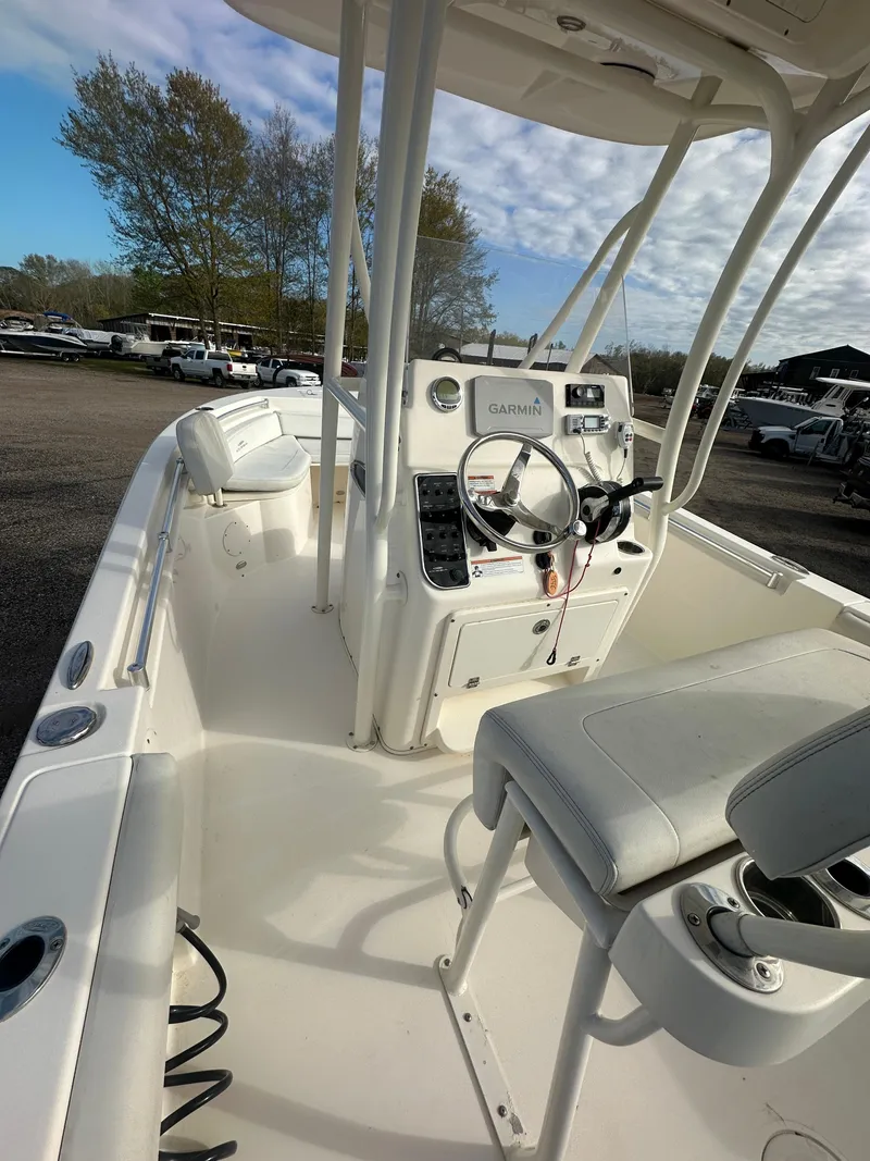 Slide: The Image of 2022 Cobia 220 Center Console boat with white interior and modern controls. - 20