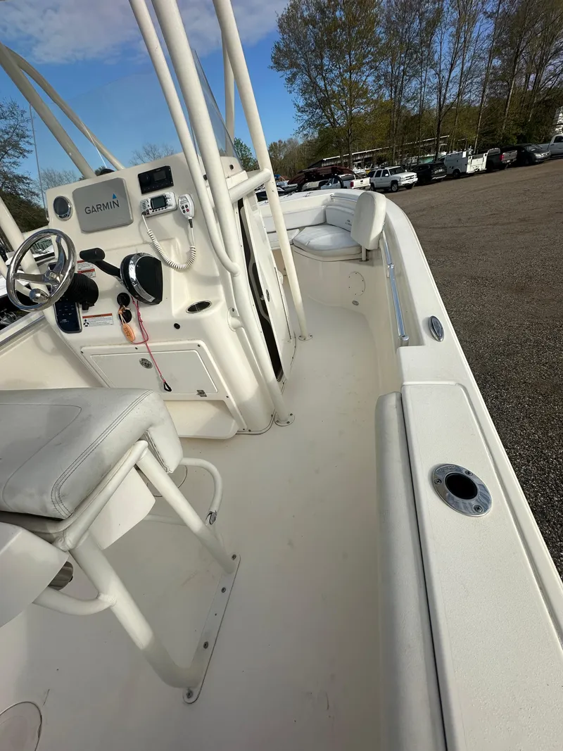 Slide: The Image of 2022 Cobia 220 Center Console boat with white interior and modern controls. - 21