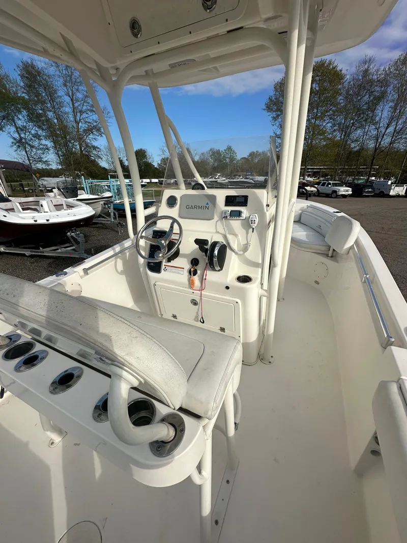 Slide: The Image of 2022 Cobia 220 Center Console boat interior with steering wheel and seating. - 24