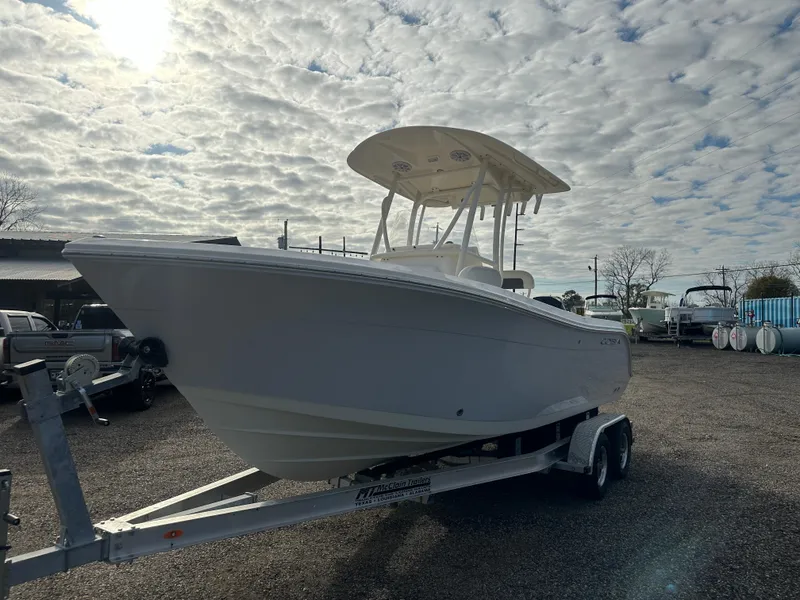 Slide: The Image of 2022 Cobia 220 Center Console boat on trailer under cloudy sky. - 4