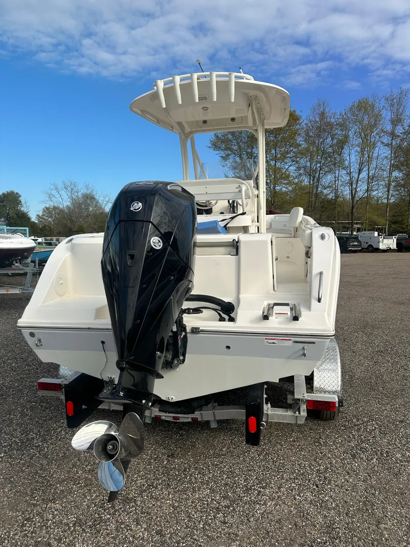 Slide: The Image of 2022 Cobia 220 Center Console boat with outboard motor on trailer. - 8