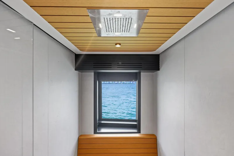 Slide: The Image of Interior view of 2023 Wally WHY 150 yacht with window overlooking the sea. - 100