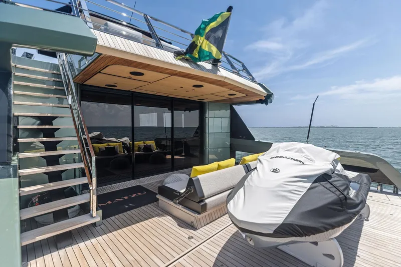 Slide: The Image of Luxury yacht Wally WHY 150, 2023 model, with deck seating and Sea-Doo jet ski. - 105