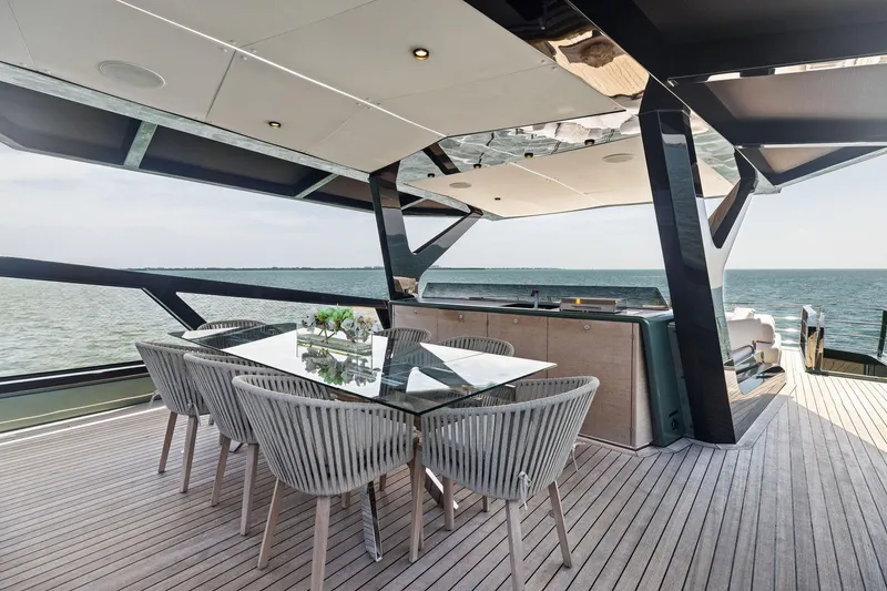 Slide: The Image of Luxurious 2023 Wally WHY 150 yacht deck with elegant dining area and ocean view. - 11
