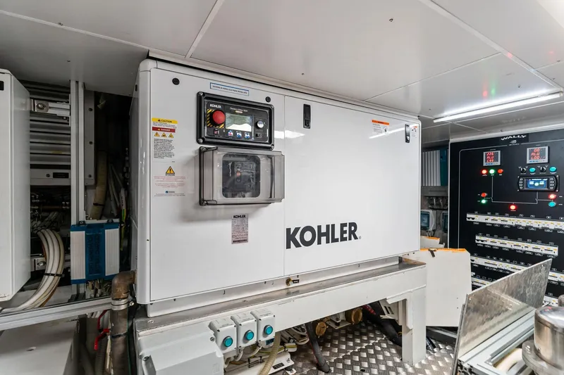 Slide: The Image of Engine room of 2023 Wally WHY 150 yacht featuring Kohler generator and control panels. - 113